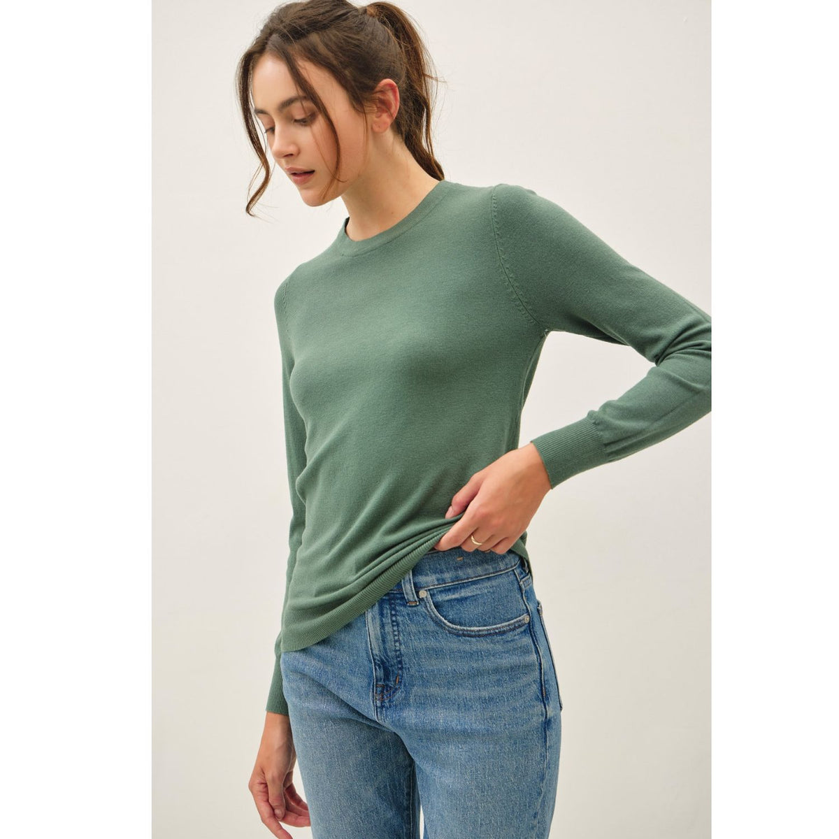 Women's sage crew neck knit sweater with long sleeves, ribbed hem and cuffs, and a relaxed fit