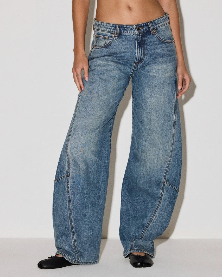 woman wearing a medium wash barrel jean
