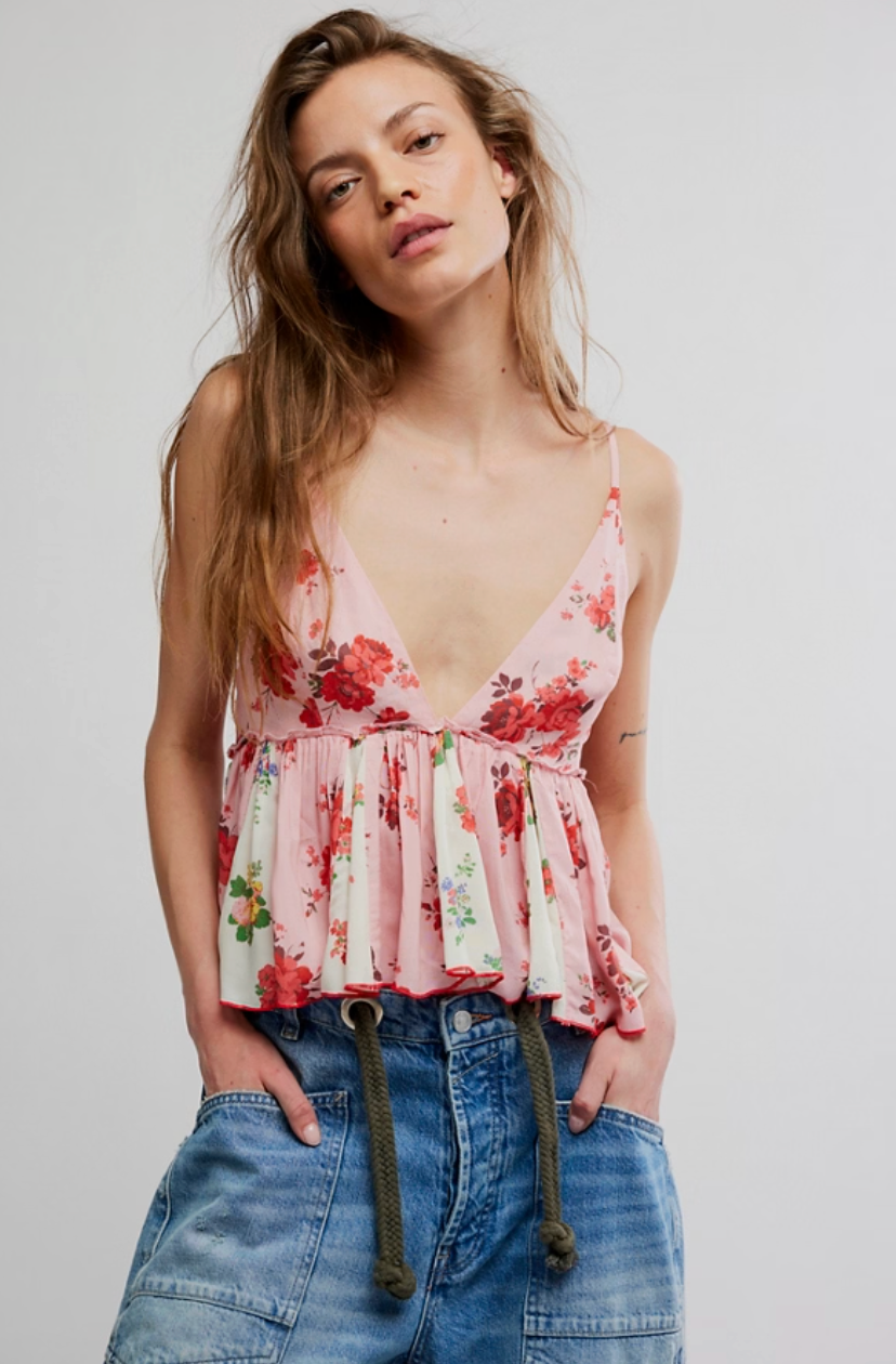 Floral print cami top with v-neckline, thin straps, and flowy ruffle hem styled with denim shorts