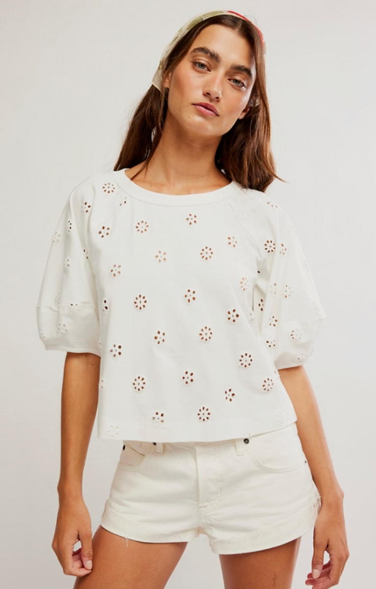 Short sleeve eyelet top with puff sleeves and relaxed fit styled with white denim shorts