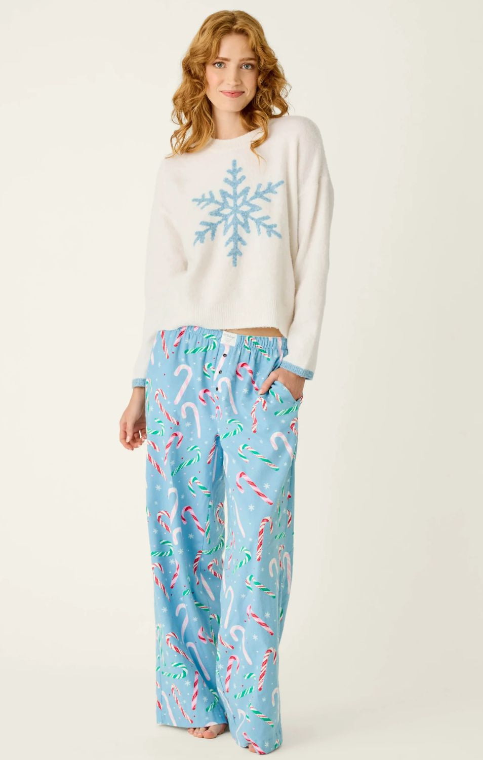 Ivory crewneck sweater with blue snowflake graphic, dropped shoulders, and contrasting blue cuffs