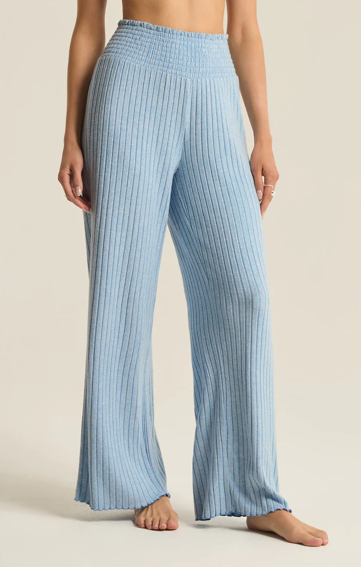 Z Supply Dawn Smocked Rib Pant Blue Jay. This pant gives all the cozy rib feels, made using ultra soft silky rib fabric. The elastic waistband plus the straight style and easy fit make this pant perfect for relaxing all day.