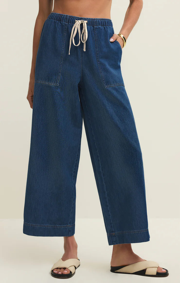 Wide-leg denim pants with drawstring waist, patch pockets, and relaxed silhouette