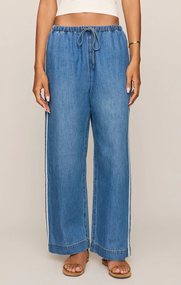 Relaxed wide-leg denim pants with an elastic drawstring waistband and an easy, flowy fit.