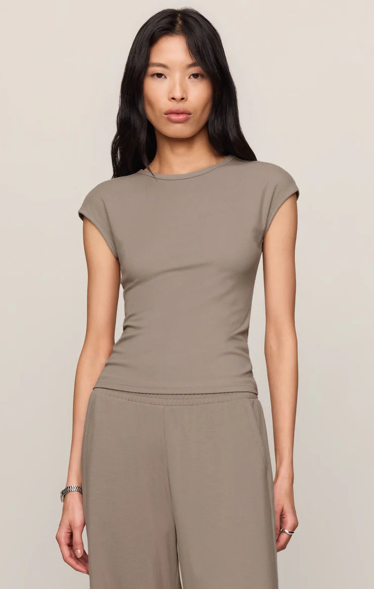 Model wearing a fitted cap sleeve knit tee with a crew neckline styled with relaxed lounge pants.