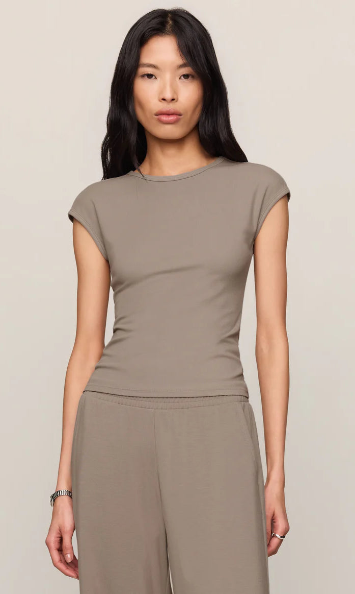 Model wearing a fitted cap sleeve knit tee with a crew neckline styled with relaxed lounge pants.