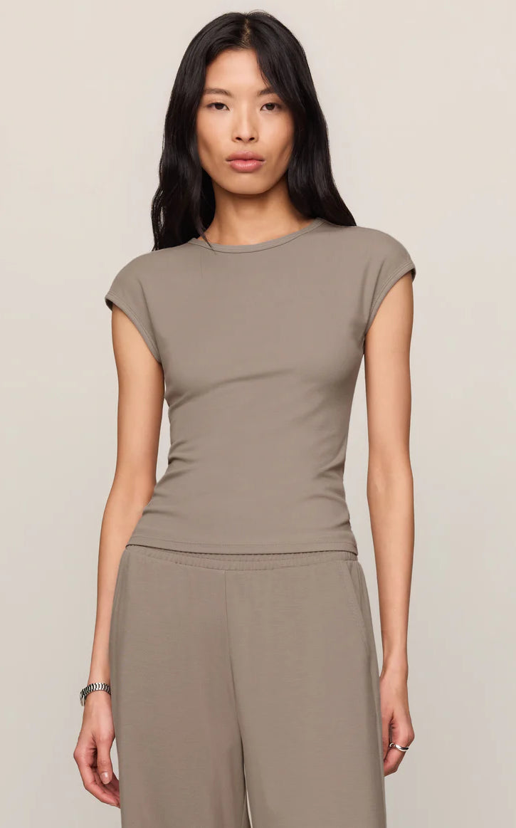 Model wearing a fitted cap sleeve knit tee with a crew neckline styled with relaxed lounge pants.