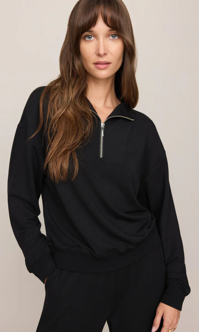 Model wearing a buttery-soft quarter-zip pullover with a relaxed fit and ribbed cuffs paired with matching lounge pants.