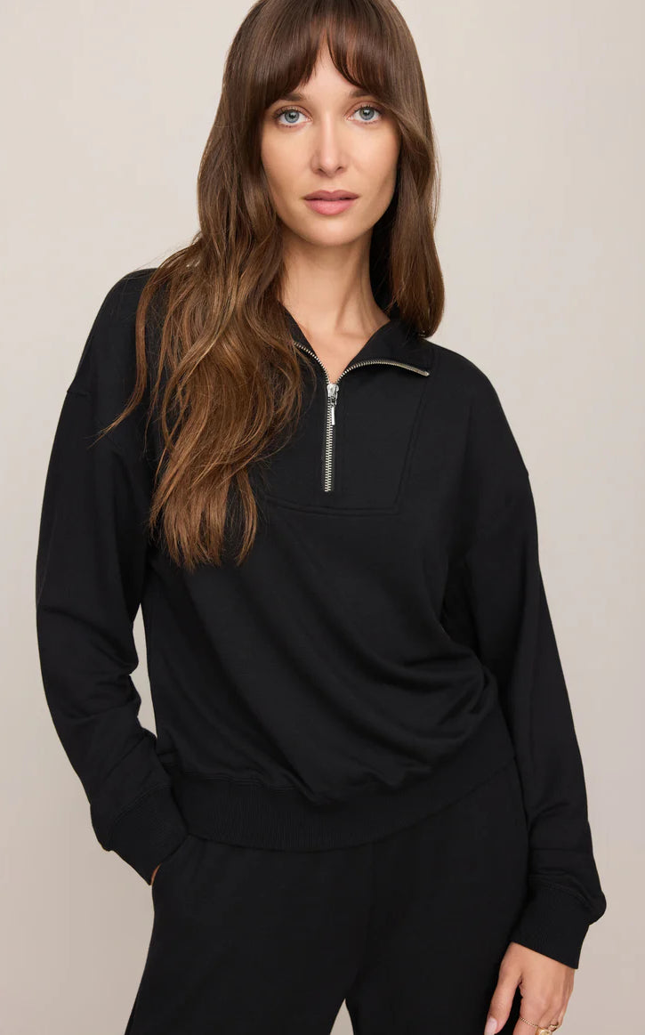 Model wearing a buttery-soft quarter-zip pullover with a relaxed fit and ribbed cuffs paired with matching lounge pants.