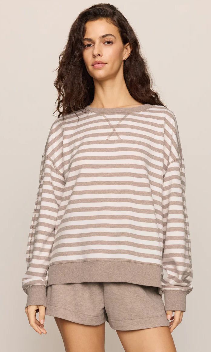 Oversized striped crewneck sweatshirt with long sleeves, ribbed trim, and a relaxed fit, styled with matching lounge shorts.