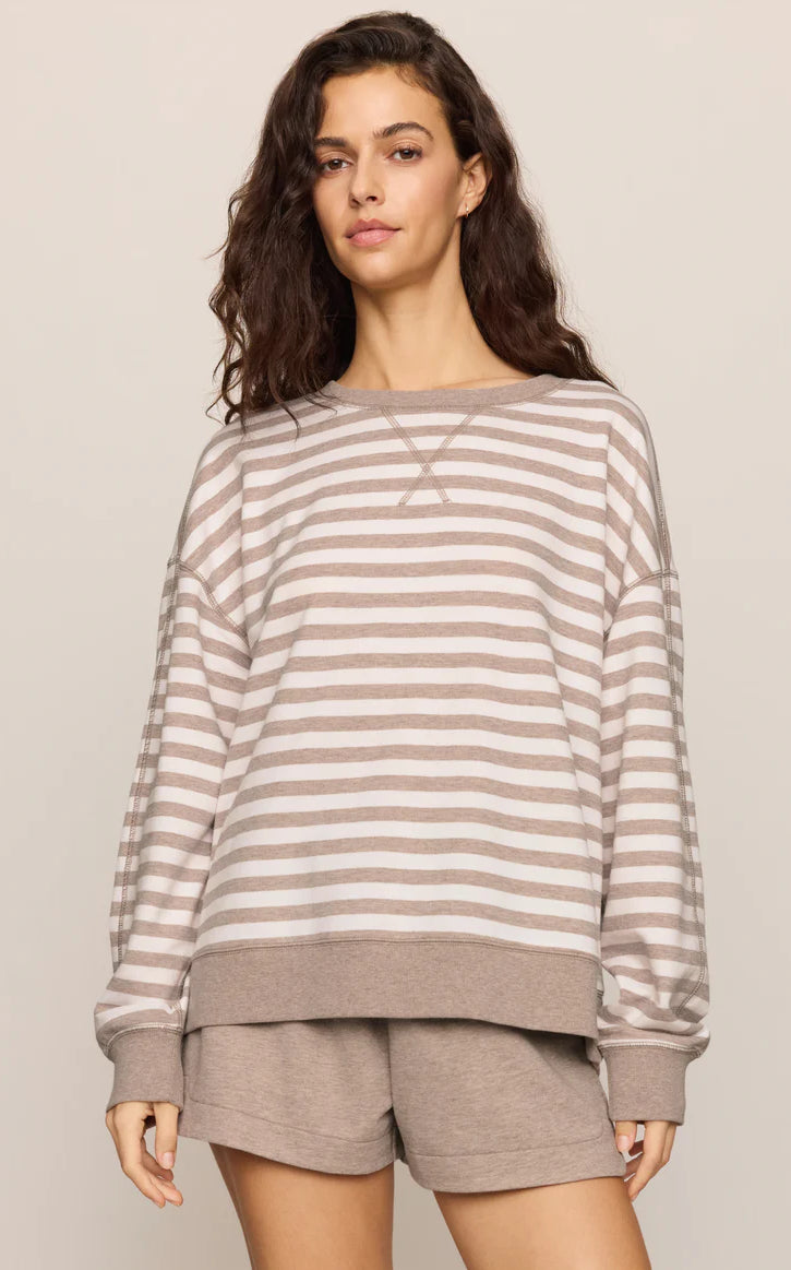 Oversized striped crewneck sweatshirt with long sleeves, ribbed trim, and a relaxed fit, styled with matching lounge shorts.