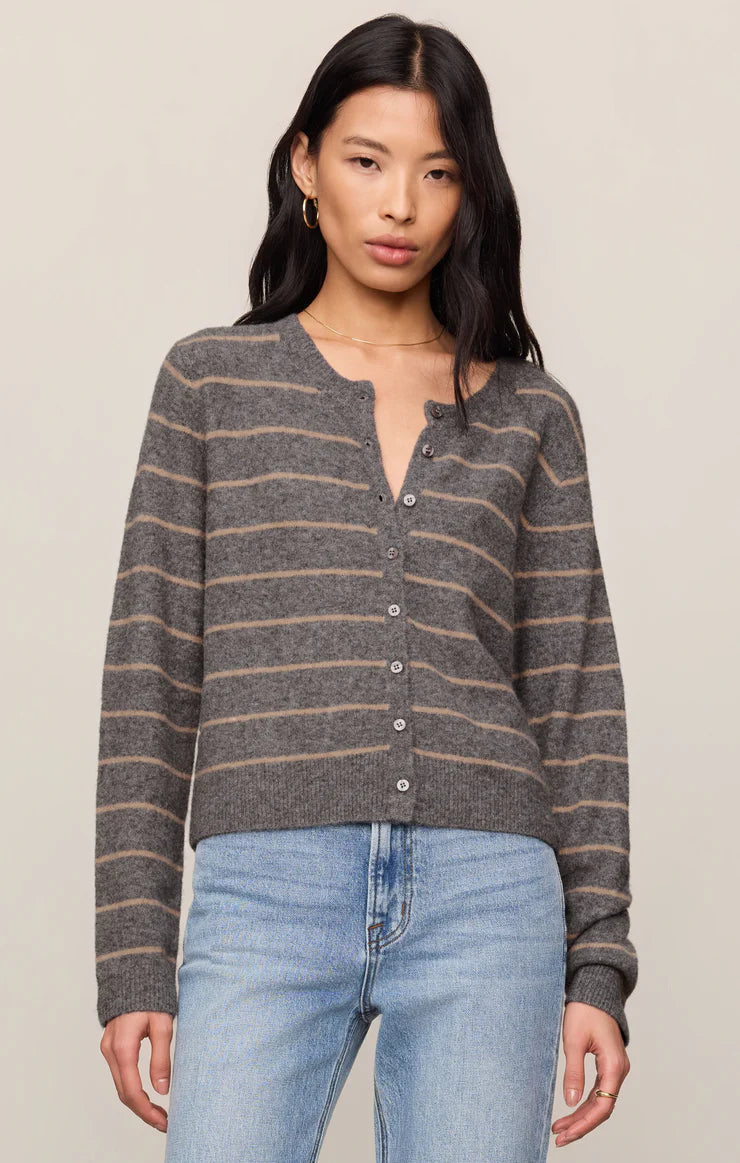 Model wearing a striped button-front knit cardigan with a relaxed fit, styled with light-wash jeans against a neutral studio background.