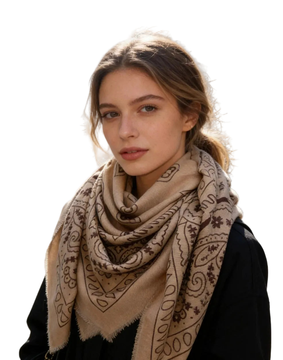 Woman wearing an oversized square scarf with a bandana-inspired paisley print and lightly fringed edges.