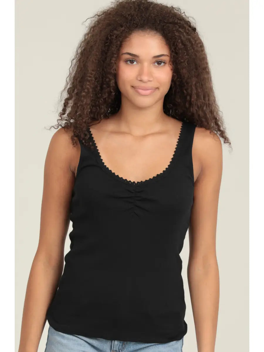 Alt Text:
Ribbed tank top with scoop neckline and fitted silhouette styled with denim jeans