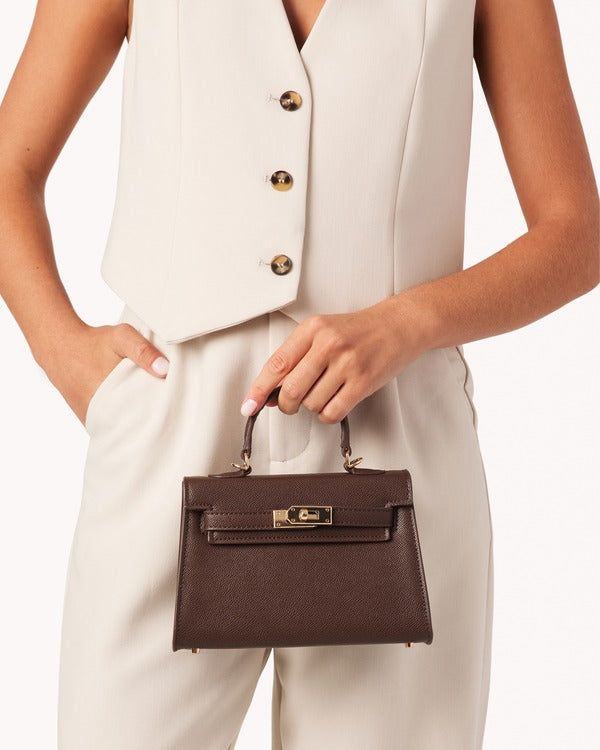 Billini Hariette Mini Handle Bag in Chocolate Saffiano, carried by hand on model