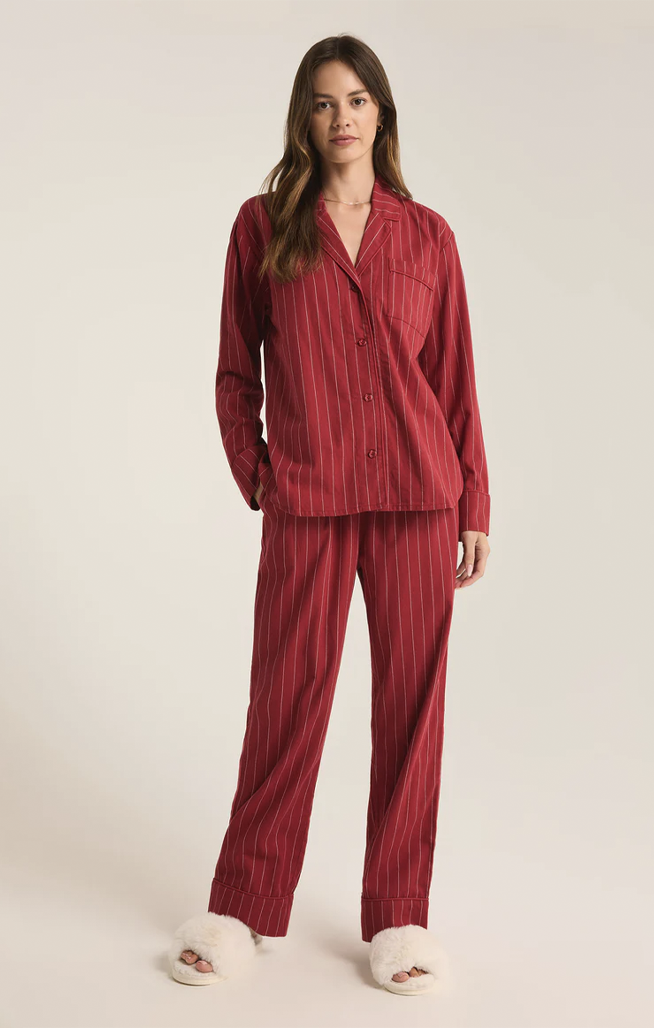 Snuggle up in this striped pajama set, crafted from soft-washed flannel for ultimate comfort. The top features a v-neck, collared button-front design with classic buttons, while the mid-rise, full-length pants offer an elastic waistband and side seam pockets. It’s the perfect cozy set to make your new go-to for relaxation.