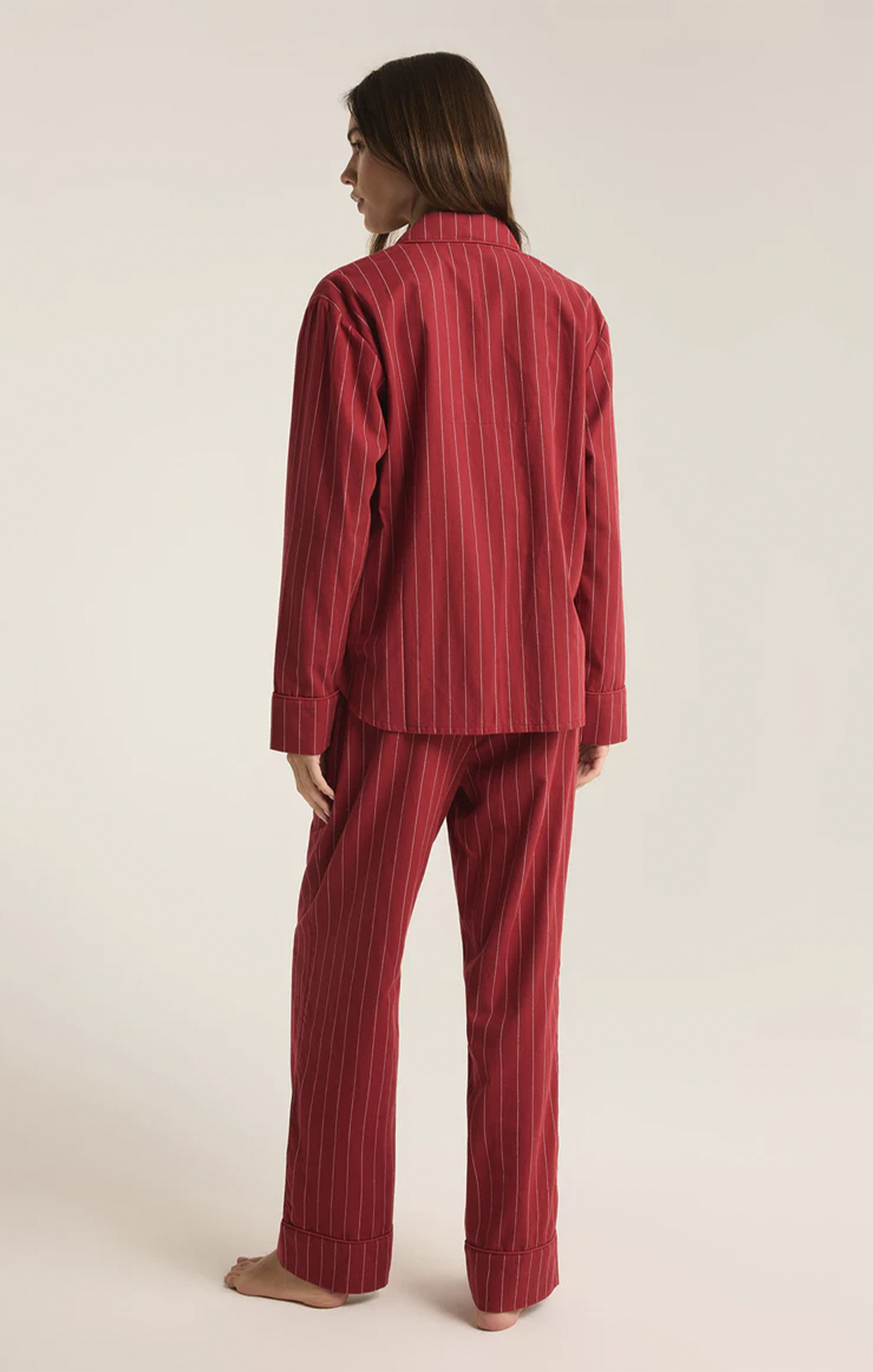Snuggle up in this striped pajama set, crafted from soft-washed flannel for ultimate comfort. The top features a v-neck, collared button-front design with classic buttons, while the mid-rise, full-length pants offer an elastic waistband and side seam pockets. It’s the perfect cozy set to make your new go-to for relaxation.