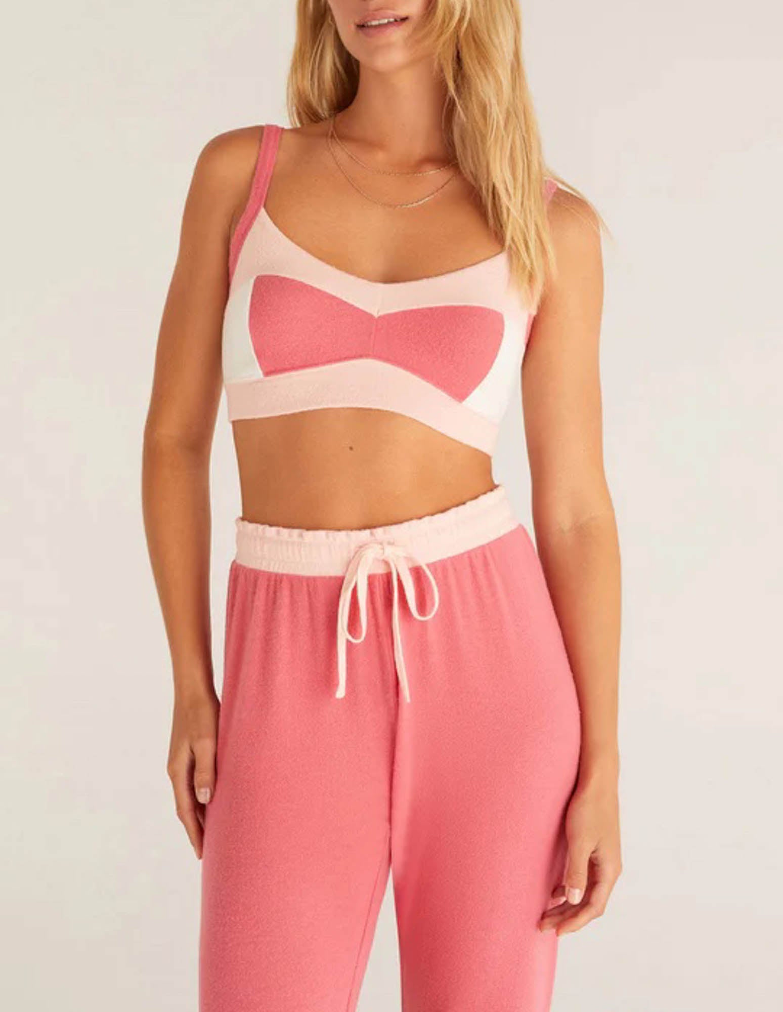 Z Supply Mix Color Tank Bra Look pretty in pink in this cute color block tank bra! This tank bra is made of ultra soft brushed sweater knit fabric and features a unique and flattering design that's to die for! Pair it with matching joggers to complete the look!