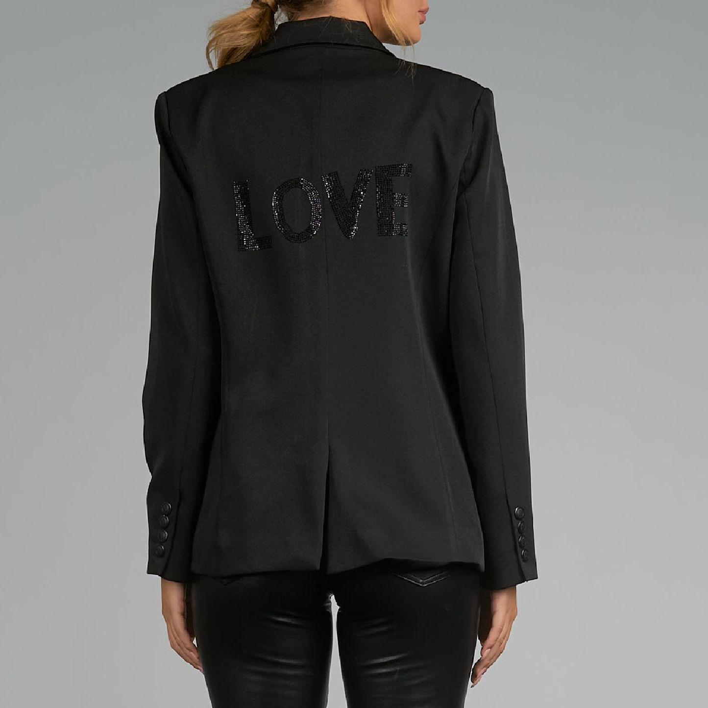 Elan Rhinestone Love Blazer. Make your casual days a bit more stylish with this layer ready blazer. Structured shoulders and a trim silhouette make this perfect for work or weekending. Best of all, the word "Love" is stoned onto the back for a dash of fun