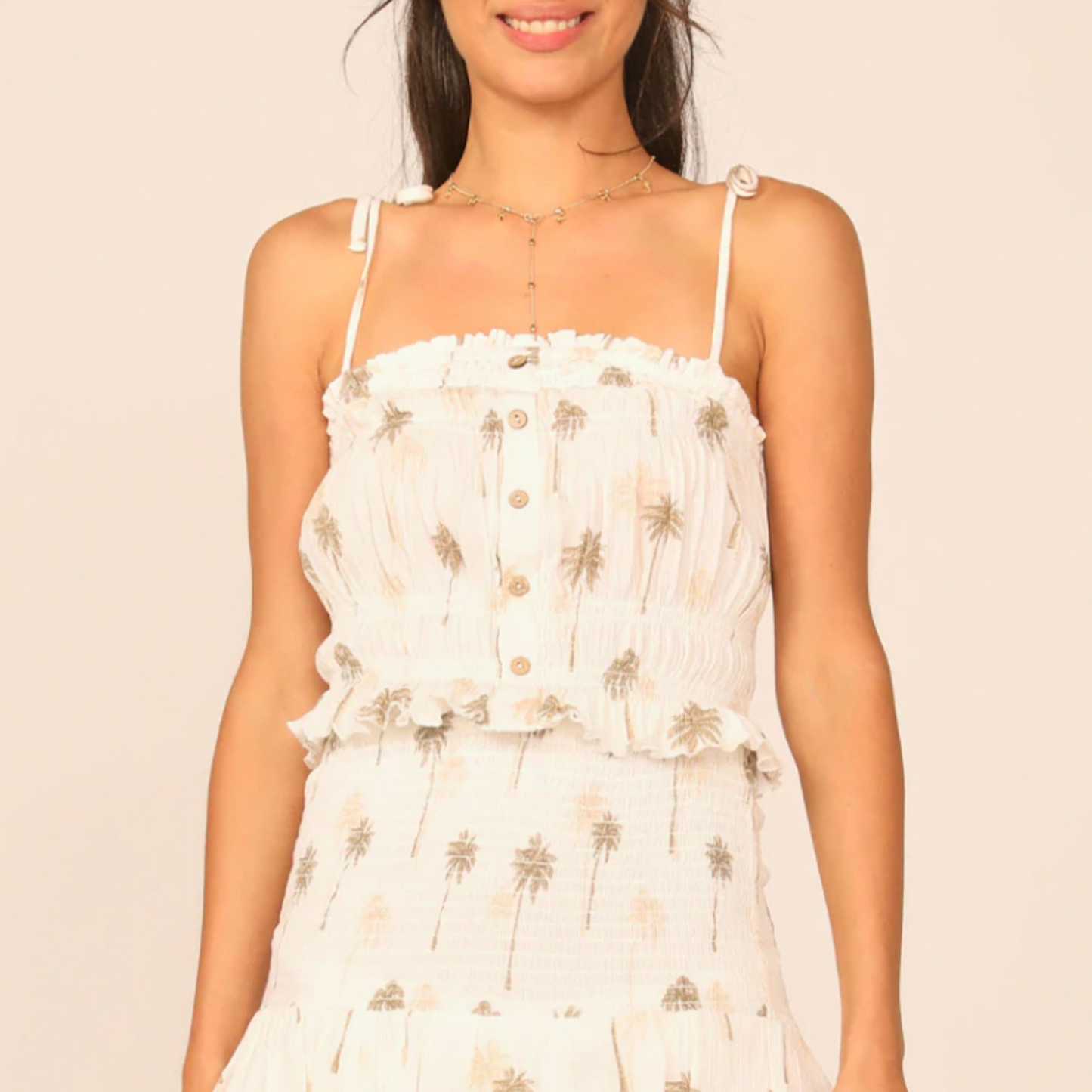 Ocean Drive Smocked Button Front Tank. Embrace the warmer weather in this smocked button down tank. Lightweight, with a summery palm tree print, shapes this top that has straps you can tie!