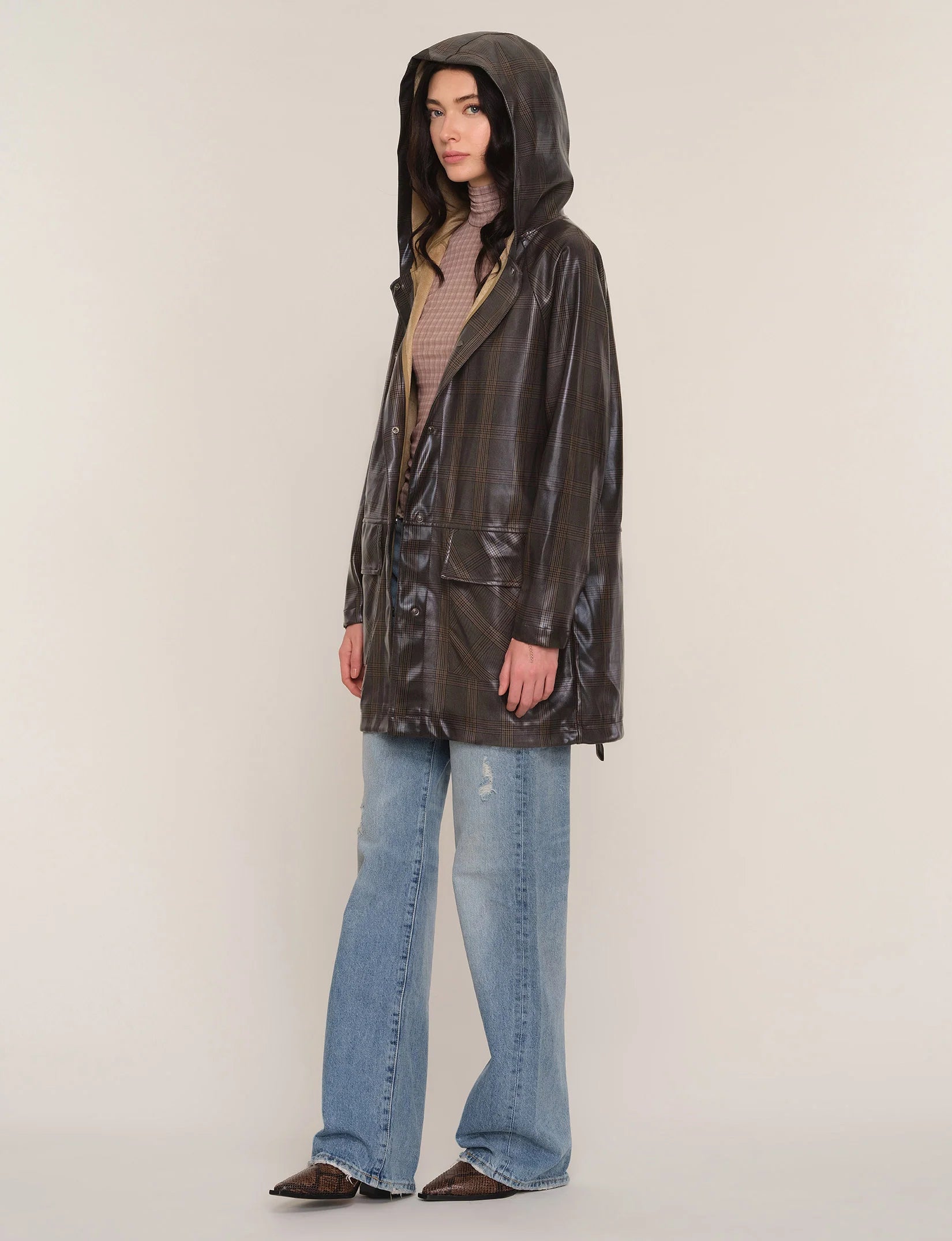 Model wearing the Heartloom Sergi Raincoat in dark plaid over jeans, full-length front view.