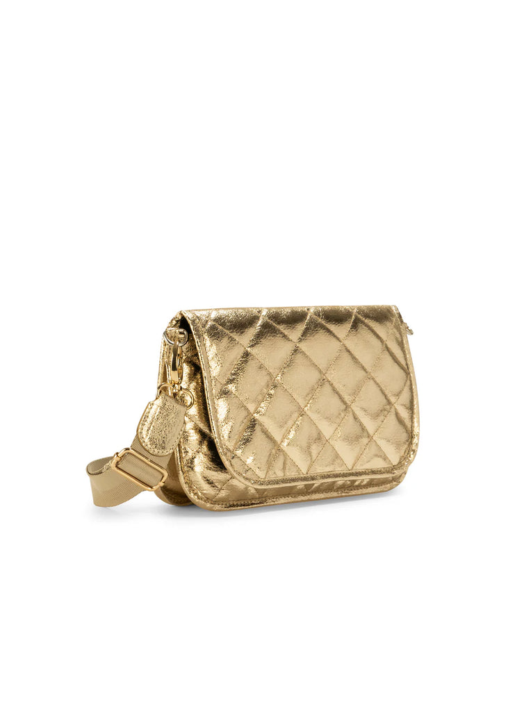 Haute Shore Rae Crossbody Gilt. This crossbody features a quilted design with a flap closure, the perfect size for everyday wear that can be used day or night as a crossbody or a clutch.