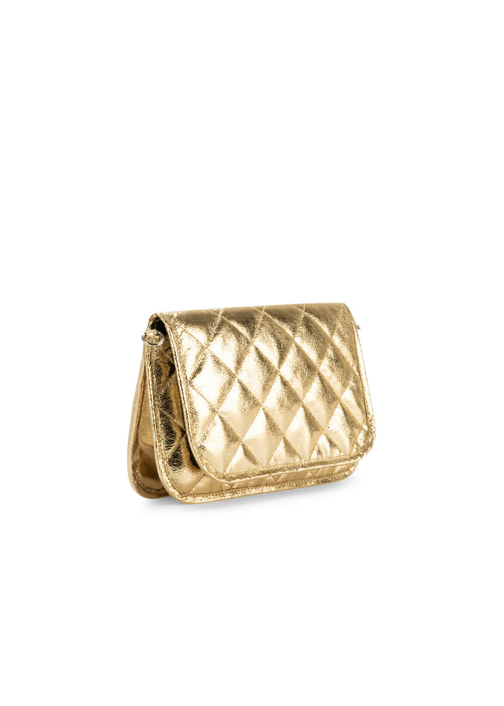 Haute Shore Rae Crossbody Gilt. This crossbody features a quilted design with a flap closure, the perfect size for everyday wear that can be used day or night as a crossbody or a clutch.