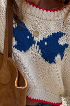 Close-up of the Mccolin Cropped Knit Sweater in Beige with blue pattern and red contrast trim.