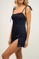 Hazel Denim Mini Dress. This denim mini dress features a sleeveless fit with tie straps and zip back closure, the perfect dress for a cute effortless look day or night.