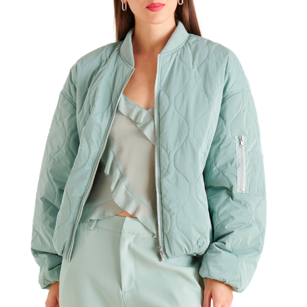 Steve Madden Vida Jacket Sage. The vida jacket features bomber-inspired design details, including a cropped silhouette, a soft nylon construction, and substantial zipper hardware.