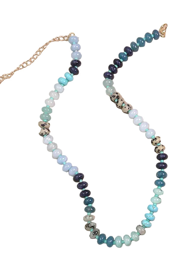 Multi-colored beaded necklace featuring shades of blue, aqua, and ivory with natural stone-inspired accents and an adjustable chain closure.