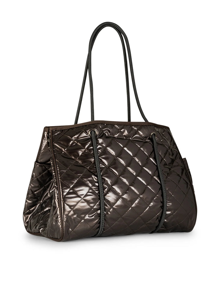 Haute Shore Greyson Smoke. This metallic quilted tote holds everything you need for when you're on the go day or night, with a lightweight adjustable design perfect for everyday.