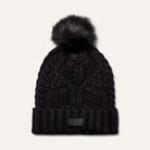 women’s pom beanie, cable knit beanie, winter hat with pom, cozy knit hat, cold weather accessories, faux fur pom hat, ribbed cuff beanie, stylish winter beanie, designer knit hat, soft winter hat, everyday beanie, warm knit accessory, winter fashion essentials, outdoor winter hat, women’s cold weather style