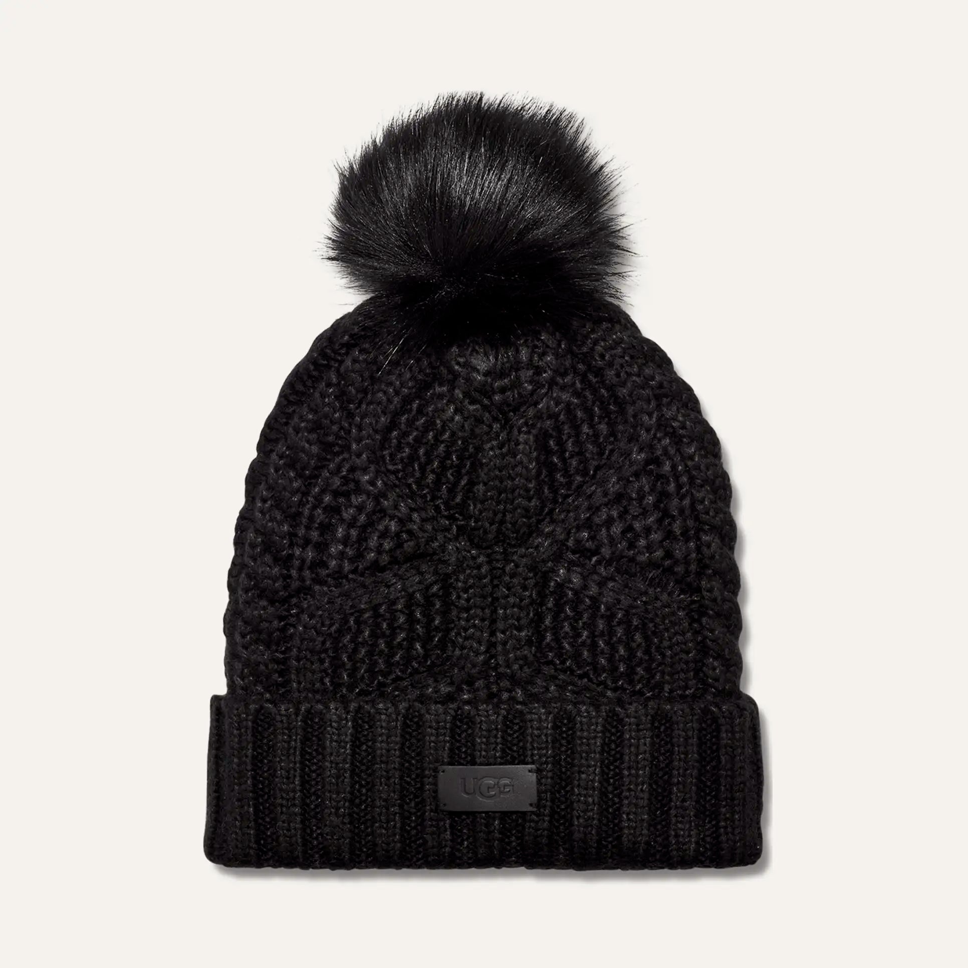 women’s pom beanie, cable knit beanie, winter hat with pom, cozy knit hat, cold weather accessories, faux fur pom hat, ribbed cuff beanie, stylish winter beanie, designer knit hat, soft winter hat, everyday beanie, warm knit accessory, winter fashion essentials, outdoor winter hat, women’s cold weather style