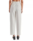 Steve Madden Rumi Pant Cream. Elevate your spring wardrobe with the Rumi Pant. These pinstripe suiting trousers are menswear inspired and feature a tapered design and pleated detailing. These trousers offer a sophisticated and polished look for any occasion.