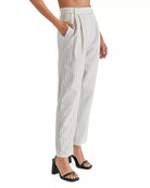 Steve Madden Rumi Pant Cream. Elevate your spring wardrobe with the Rumi Pant. These pinstripe suiting trousers are menswear inspired and feature a tapered design and pleated detailing. These trousers offer a sophisticated and polished look for any occasion.