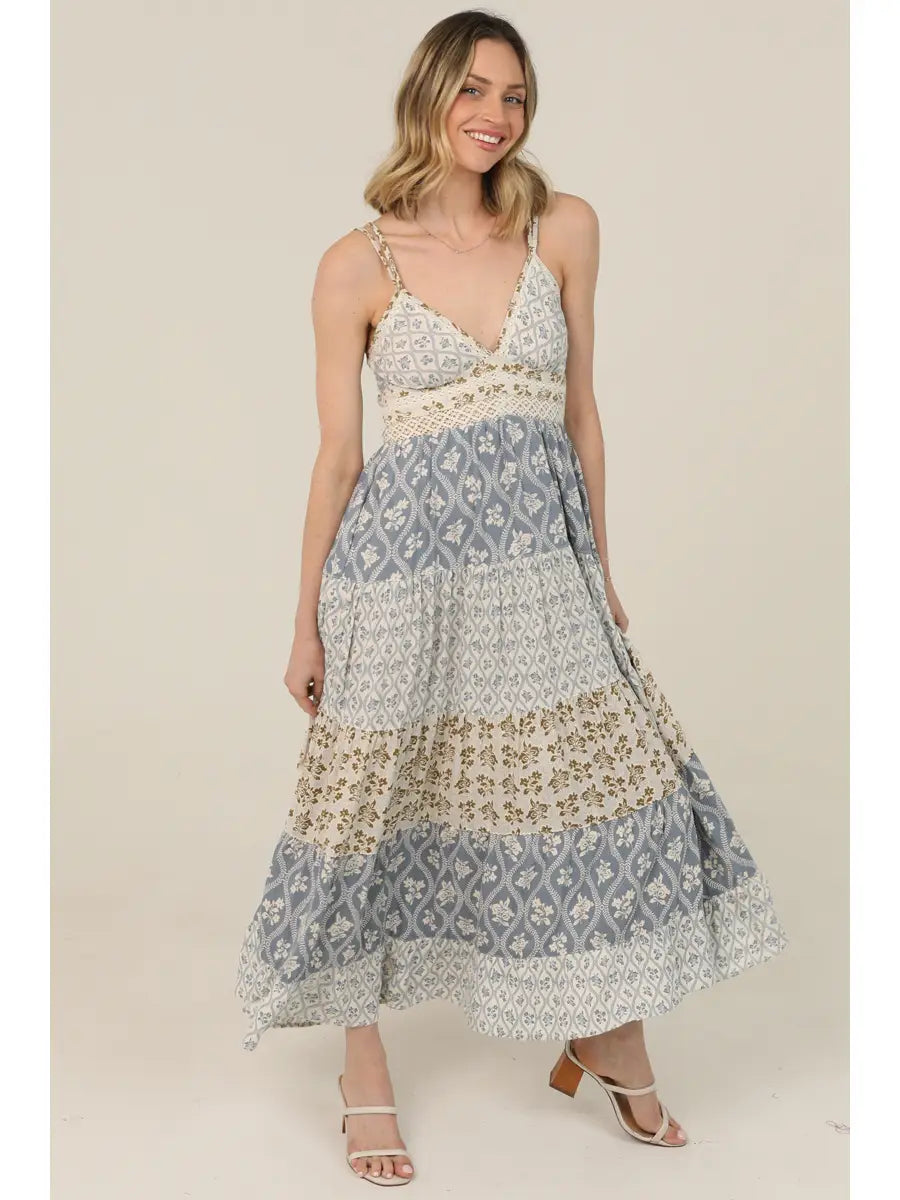 Women's patchwork print maxi dress with crochet detailing, adjustable straps, tiered skirt, and mixed floral patterns.