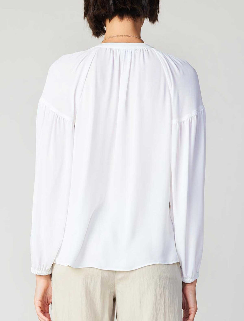 Current Air Split Neck Blouse White. This long sleeve split neck blouse is a must have essential to add to your closet, where it tucked in for a more tailored look or out as a flowy blouse.