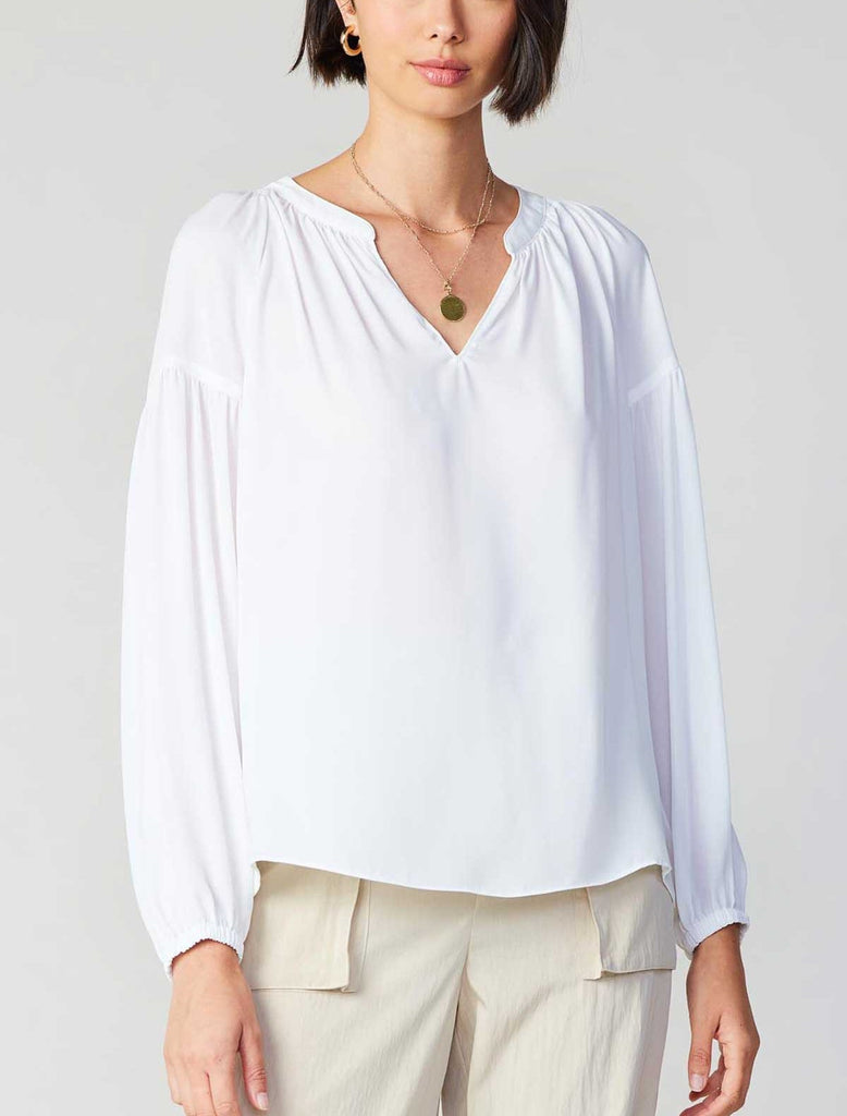 Current Air Split Neck Blouse White. This long sleeve split neck blouse is a must have essential to add to your closet, where it tucked in for a more tailored look or out as a flowy blouse.