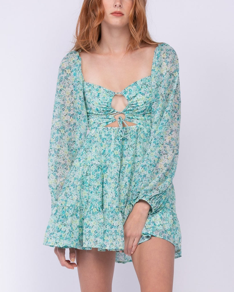 Evelyn Floral Mini Dress Mint. This mini dress features a floral print with long sleeves and smocked back, the subtle cut out details in the front and back add the perfect extra touch of cool and cute.
