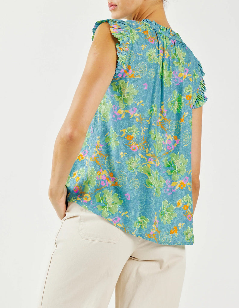 Current Air Floral Ruffle Pleated Blouse Blue Multi Print. This mood-boosting floral abstract blouse is a bright delight. The popover silhouette has a relaxed silhouette with the sweetest details—ruffle trim, split neckline with a delicate self-tie, and pleated cap sleeves.