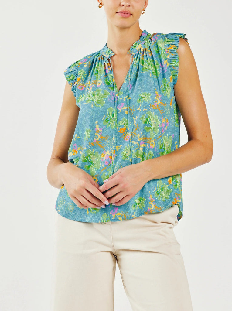 Current Air Floral Ruffle Pleated Blouse Blue Multi Print. This mood-boosting floral abstract blouse is a bright delight. The popover silhouette has a relaxed silhouette with the sweetest details—ruffle trim, split neckline with a delicate self-tie, and pleated cap sleeves.