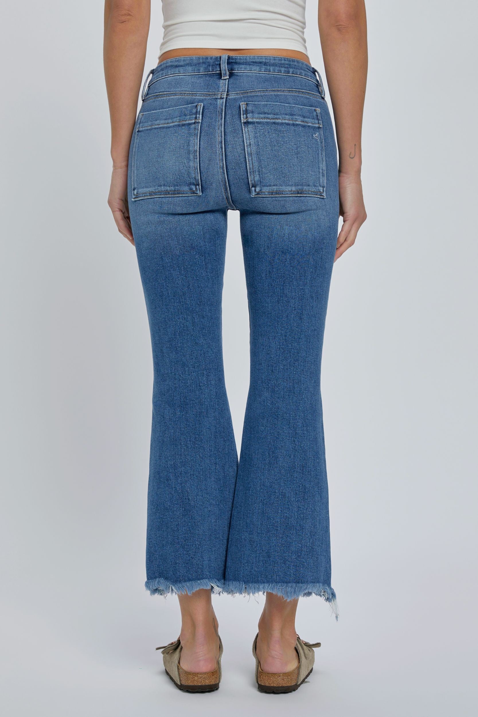 Hidden Inseam Happi Cargo Flare Medium Dark. These trendy flare jeans feature cargo front pockets and a frayed bottom hem in a comfortable stretch denim fabric that's perfect for everyday.