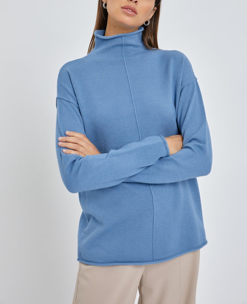 Moonbeam Line Detail Sweater Blue. This cozy sweater features line details down the front and back and a mock neckline with a rolled hemline, a closet must have for fall and winter.