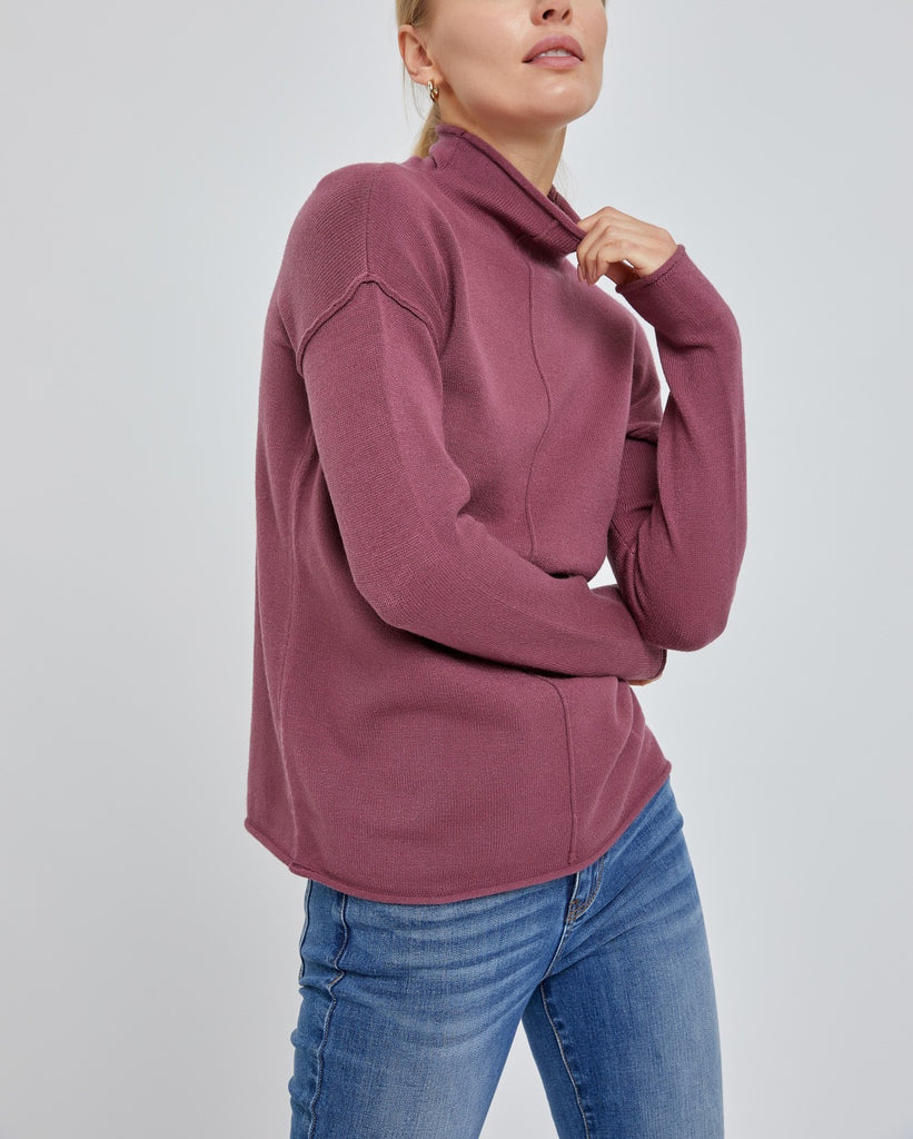 Moonbeam Line Detail Sweater Maroon. This cozy sweater features line details down the front and back and a mock neckline with a rolled hemline, a closet must have for fall and winter.