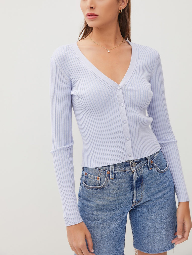 Amina Rib V-Neck Slim Cardi Baby Blue. This slim fit cardigan features a v-neckline and button down front in a soft ribbed fabric, perfect for wearing open for an extra layer or on its own buttoned closed.