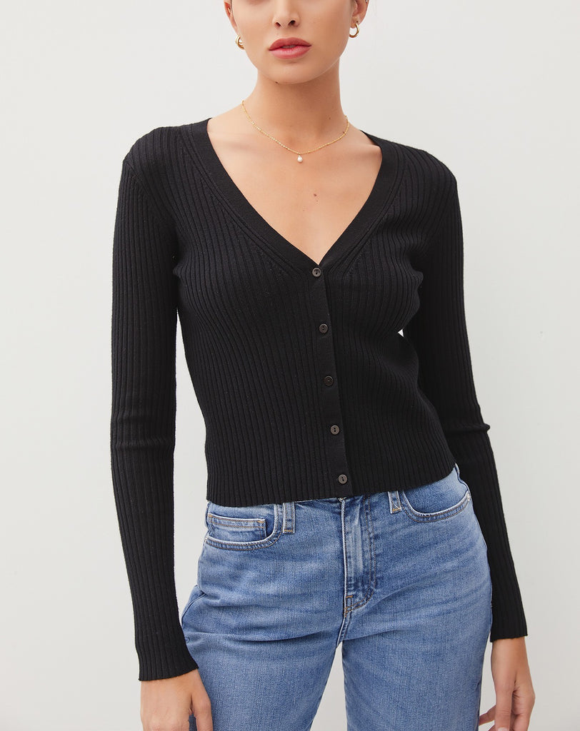 Amina Rib V-Neck Slim Cardi Black. This slim fit cardigan features a v-neckline and button down front in a soft ribbed fabric, perfect for wearing open for an extra layer or on its own buttoned closed.
