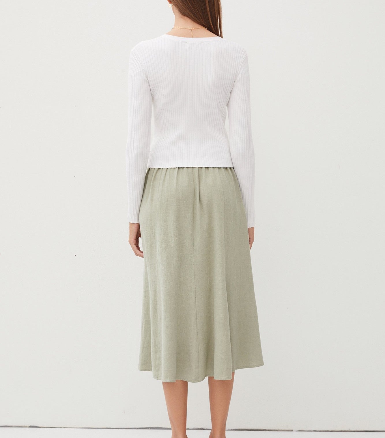 Amina Rib V-Neck Slim Cardi White. This slim fit cardigan features a v-neckline and button down front in a soft ribbed fabric, perfect for wearing open for an extra layer or on its own buttoned closed.