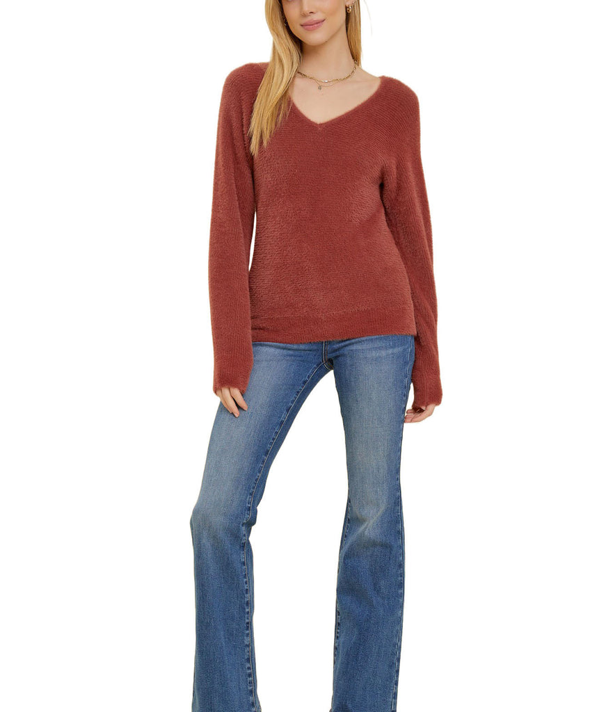 Fuzzy Luxe V-Neck Sweater Terracotta. This sweater is made with ultra cozy fuzzy material and features a flattering v-neckline and subtle ribbing, perfect for staying warm, cozy and cute.