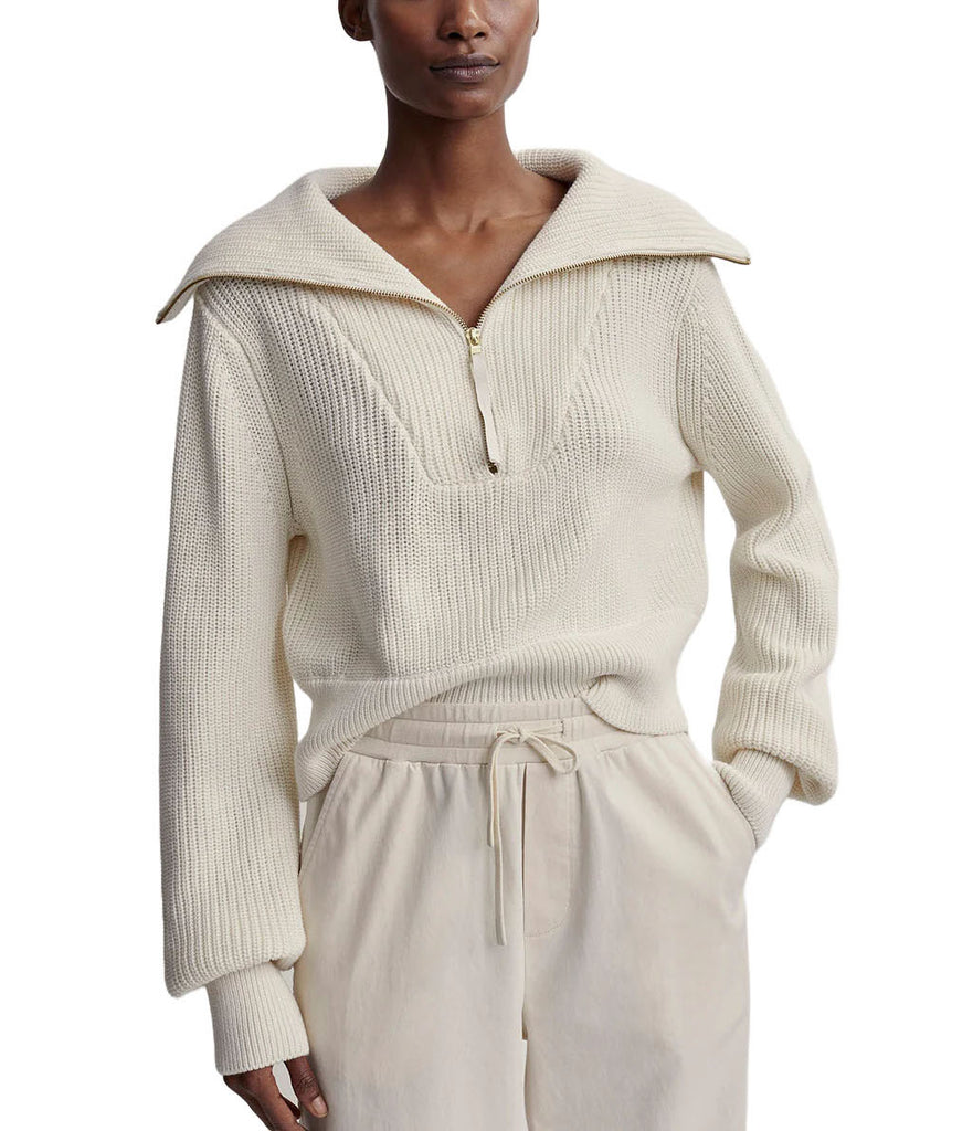 Varley Mentone Knit Off White Egret. A timeless and luxurious wear-anywhere knit. The Mentone features a half zip design in a cozy knit fabric with an oversized collar for a tailored timeless look.